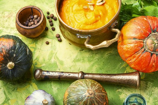 Vegetarian autumn pumpkin cream soup.Pumpkin soup and pumpkins