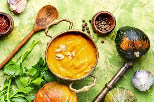 Vegetarian autumn pumpkin cream soup.Pumpkin soup and pumpkins