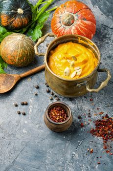 Vegetarian autumn pumpkin cream soup.Pumpkin soup and pumpkins