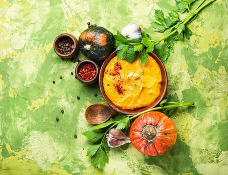 Vegetarian autumn pumpkin cream soup.Pumpkin soup and pumpkins.Flat lay with copy space