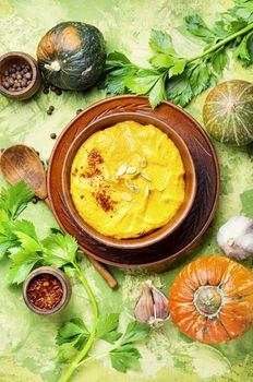 Vegetarian autumn pumpkin cream soup.Pumpkin soup and pumpkins