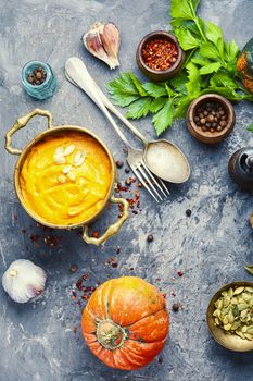 Vegetarian autumn pumpkin cream soup.Pumpkin soup and pumpkins