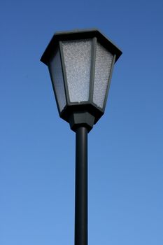 A decorated street lamp, blue sky in the background