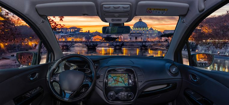 Looking through a car windshield with view over Saint Peter's Church during a wonderful sunset in Rome, Italy