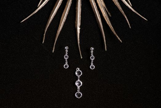 Jewelry. Women's jewelry.Handmade earrings on a black background close-up, selective focus.