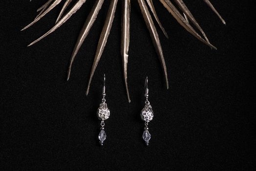 Jewelry. Women's jewelry.Handmade earrings on a black background close-up, selective focus.