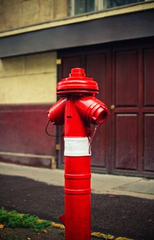 Close up shot of a red fire hydrant on a sidewalk of a street. Fire hydrant for emergency fire access.