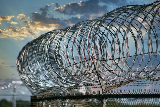 Razor wire atop security fence at military base