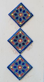 Three Tiles on Plaster Wall