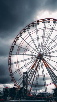 Batumi, Georgia - August, 2019 Moving metal sculpture Ali and Nino by Tamara Kvesitadze and Ferris wheel