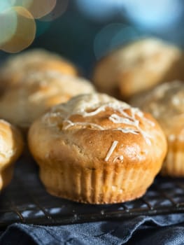 Delicious savory salted muffins with cream cheese, herbs and spices, topping grated parmesan. Close up view, selective focus.