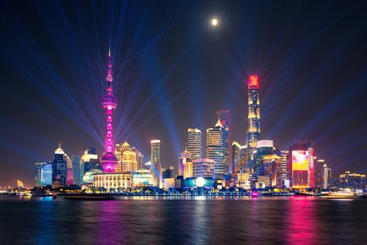 laser show over illuminated Lujiazui skyline and Huangpu river at night, Shanghai, China