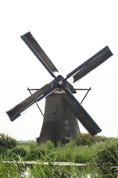 A beautiful, old, historic windmill, with four wings 