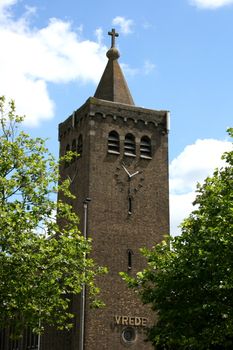 Imposing church tower with blue sky in the background