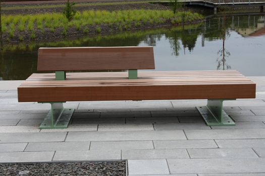 a modern park bench, with river in the background