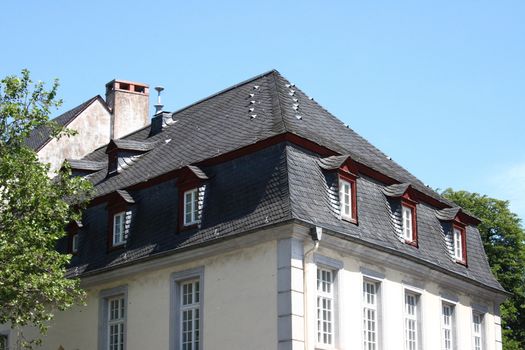 A slate roof with Windows and dormers