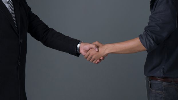 Image businessman handshake , Hand holding on gray background