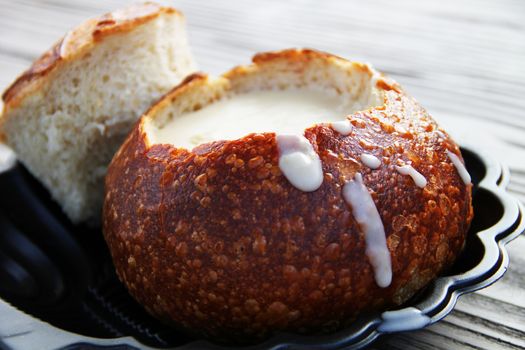 The most famous and popular in San Francisco mussel soup in a pot of bread