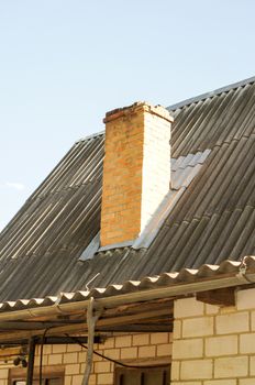 Smoker on the roof of the summer kitchen at the cottage on a summer day. For your design