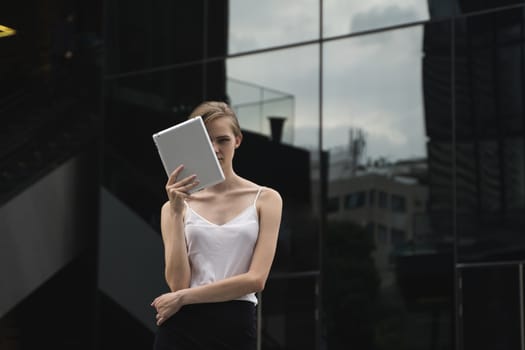 Portrait of business woman holding a tablet computer