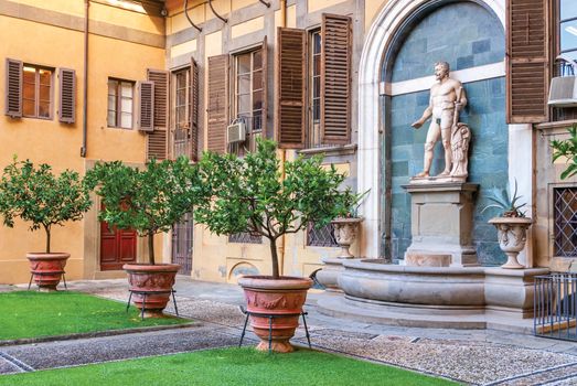 Outer courtyard of the Medici Riccardi Palace, which has an Italian garden with statues and tubs with plants. Florence, Italy