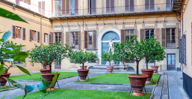 Outer courtyard of the Medici Riccardi Palace, which has an Italian garden with statues and tubs with plants. Florence, Italy