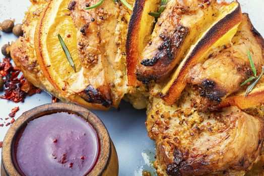 Baked pork meat stuffed with orange and seasonings.Grilled pork with orange fruit