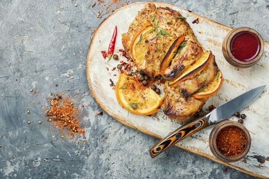 Baked pork meat stuffed with orange and seasonings.Grilled pork with orange fruit