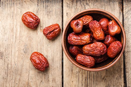 Bowl of dried unabi fruit or jujube.Space for text