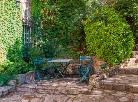 Spain, Tossa de Mar, cobbled street, staircase and stone wall in medieval Old Town.