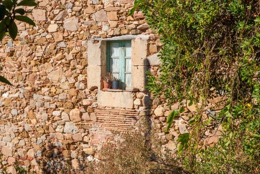 Wall and Antique window in the old town of Tossa de Mar