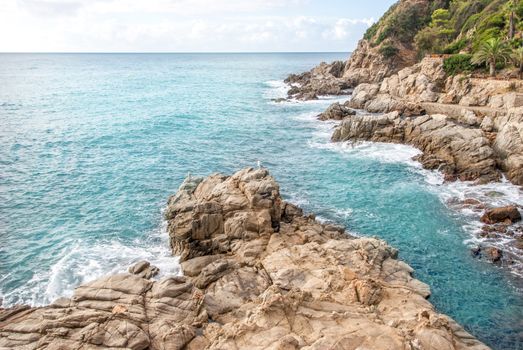 Rocks on the coast of Lloret de Mar in a beautiful summer day, Costa Brava, Catalonia