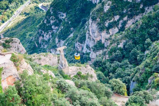 Yellow cable car in the Aeri de Montserrat rise to de Montserrat Abbey near Barcelona, Spain, Catalonia