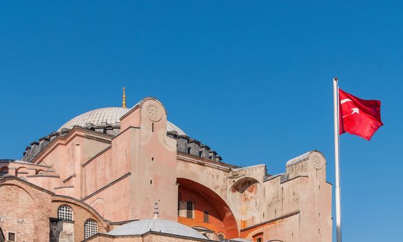 Turkish flag waves outside of Hagia Sophia museum in Istanbul, Turkey