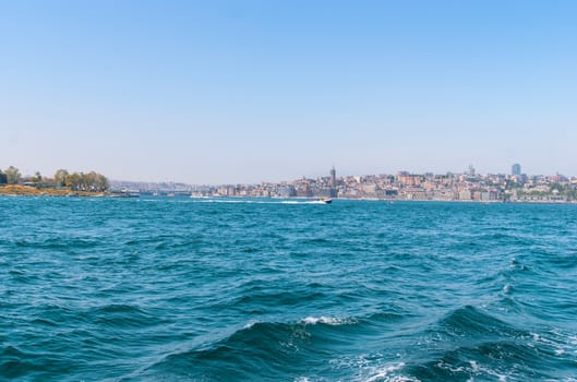 View from the water on the historical center of Istanbul. View of the Galata bridge, Eminonu district and square and Balik Ekmek boat shops.