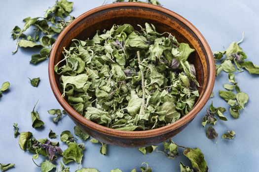 Bowl of dried oregano leaves.Organic dry herbs