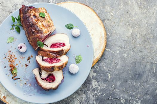 Baked pork meat stuffed with cherries.Baked pork.