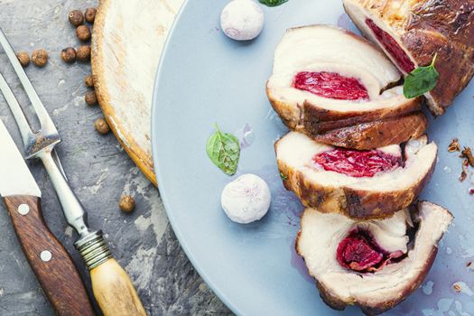 Baked pork meat stuffed with cherries.Baked pork.