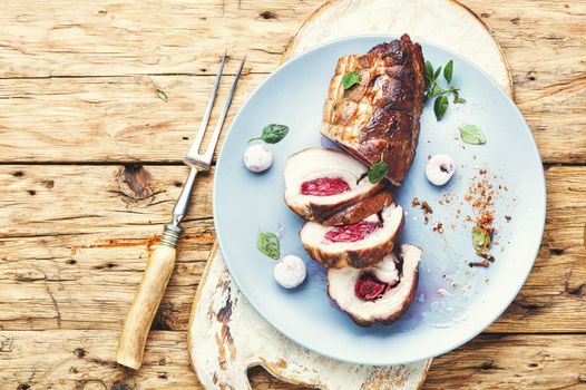 Roasted pork with cherry filling.Baked pork in a baking dish