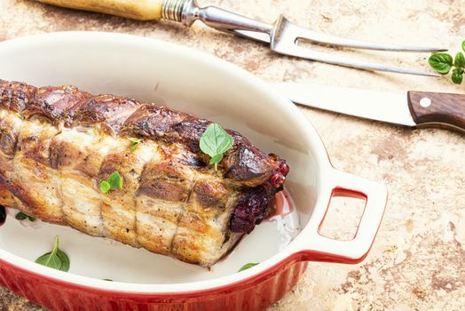 Baked pork meat stuffed with cherries.Baked pork.