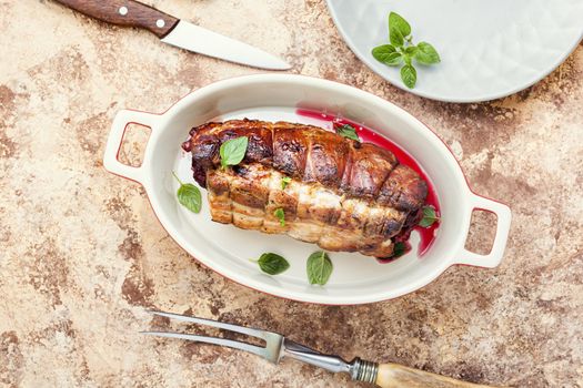 Roasted pork with cherry filling.Baked pork in a baking dish