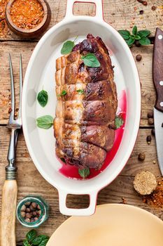 Roasted pork with cherry filling.Baked pork in a baking dish