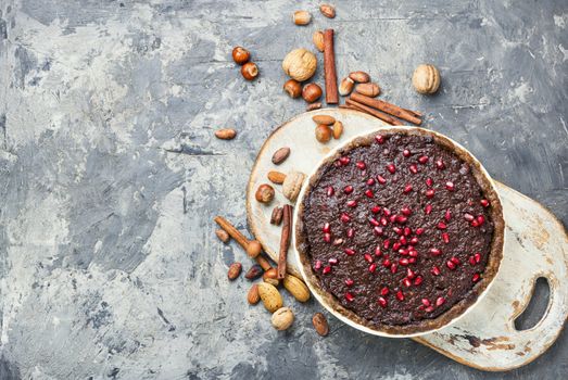 Tasty homemade chocolate cake with pomegranate and nut.