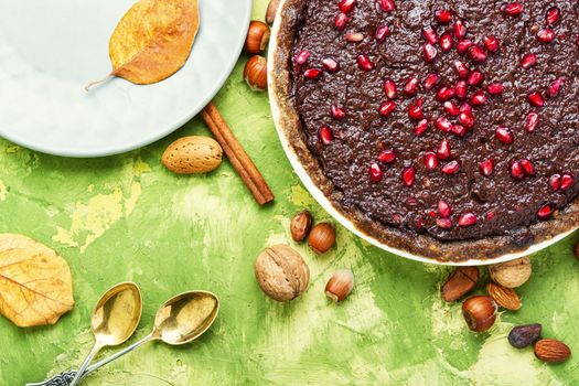 Delicious chocolate cake with pomegranate and nut.