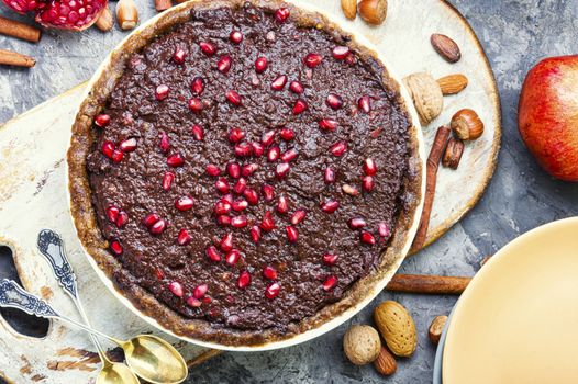 Delicious chocolate cake with pomegranate and nut.
