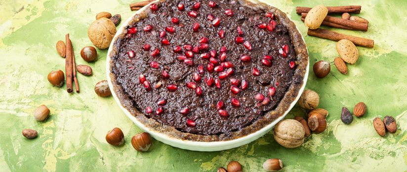 Delicious chocolate cake with pomegranate and nut.Chocolate brownie cake