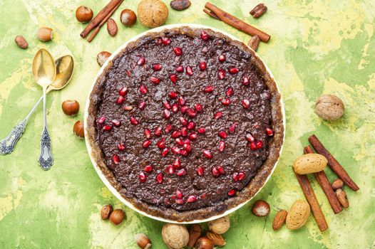 Delicious chocolate cake with pomegranate and nut.Chocolate brownie cake