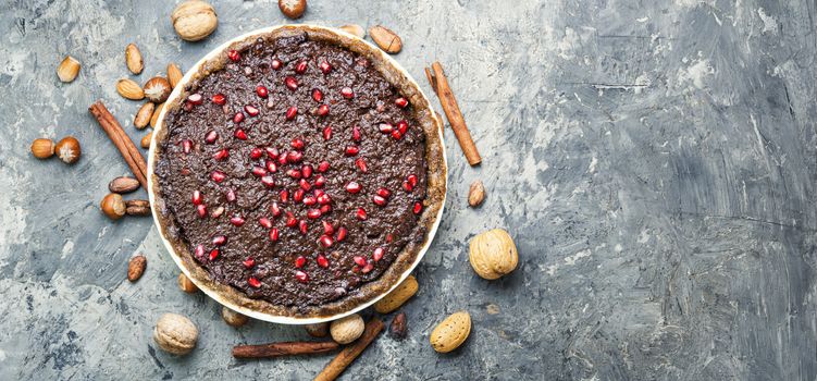 Tasty homemade chocolate cake with pomegranate and nut.Flat lay with copy space