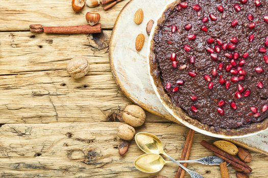 Tasty homemade chocolate cake with pomegranate and nut.