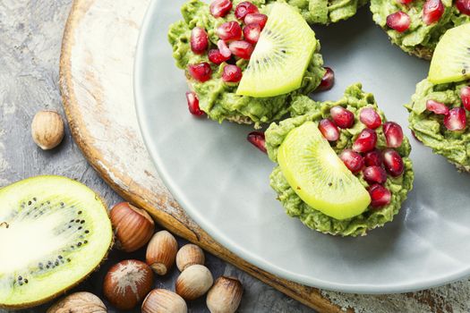 Avocado cupcakes or muffin garnished with kiwi and pomegranate.Cupcakes, close-up.